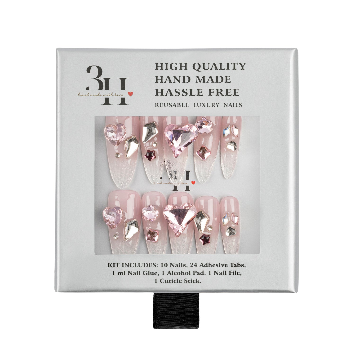 A boxed set of reusable press-on nails in a light gray package. The nails are pale pink with clear rhinestone embellishments and a large heart-shaped pink gem on the front.