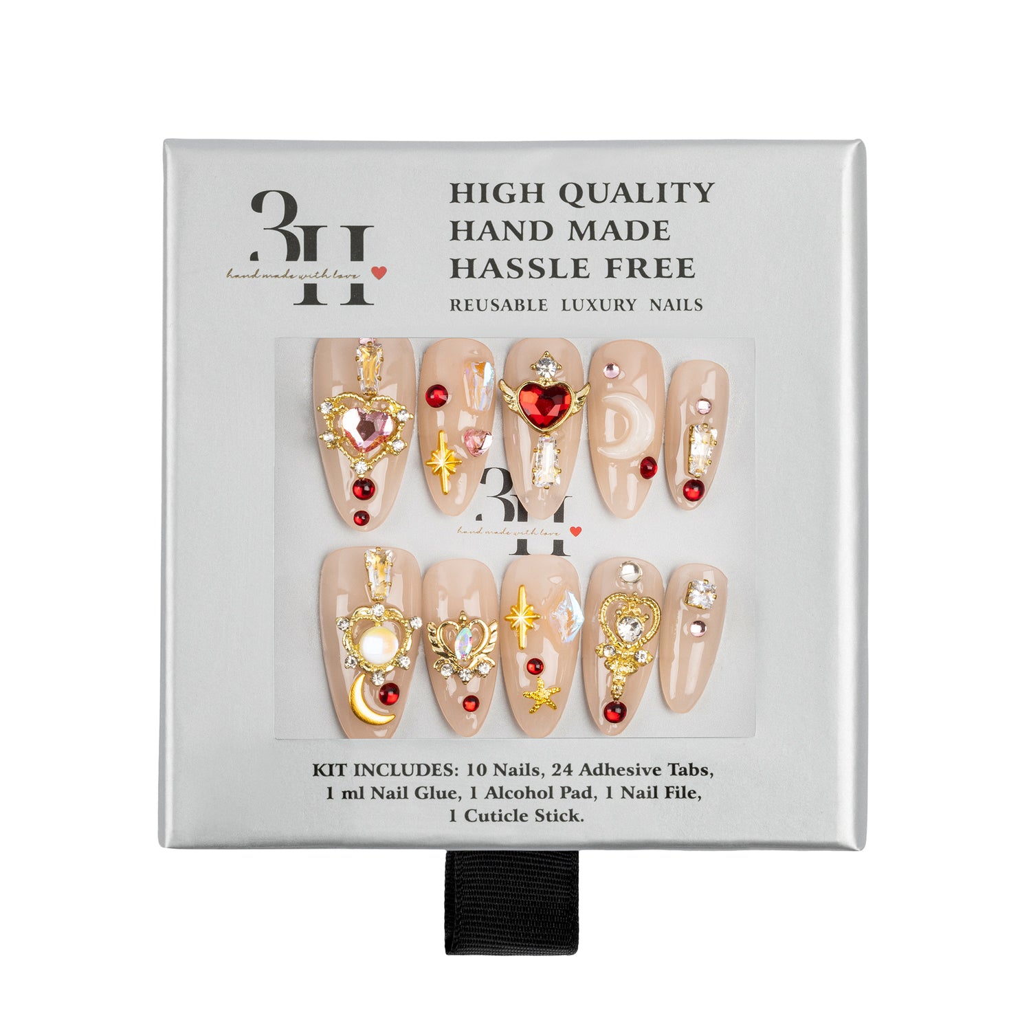 A 10-piece reusable press-on nail kit in its original packaging, featuring beige almond-shaped nails decorated with gold glitter, rhinestones, and red heart accents.