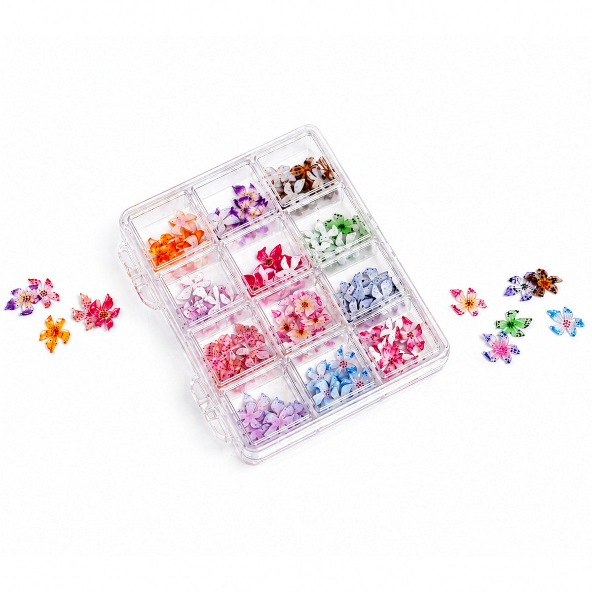 Assorted Orchid Blossom nail charms by 3H Nails displayed in a case, featuring delicate floral designs for nail art.