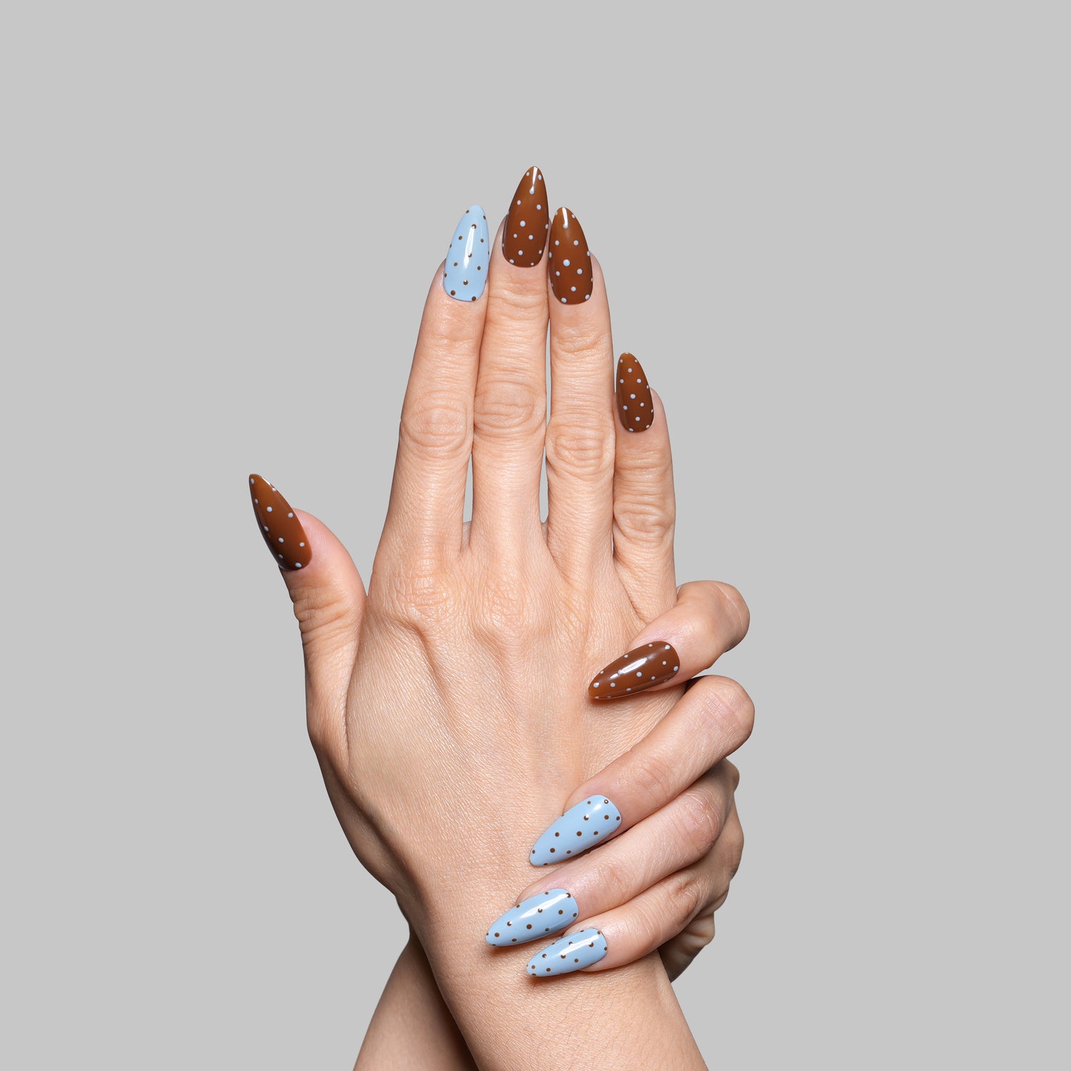 Hand holding 3H Nails 3H Luxury Handmade Press-on Nails in Pebbles design, showcasing natural nail extension and decorative pebble accents.