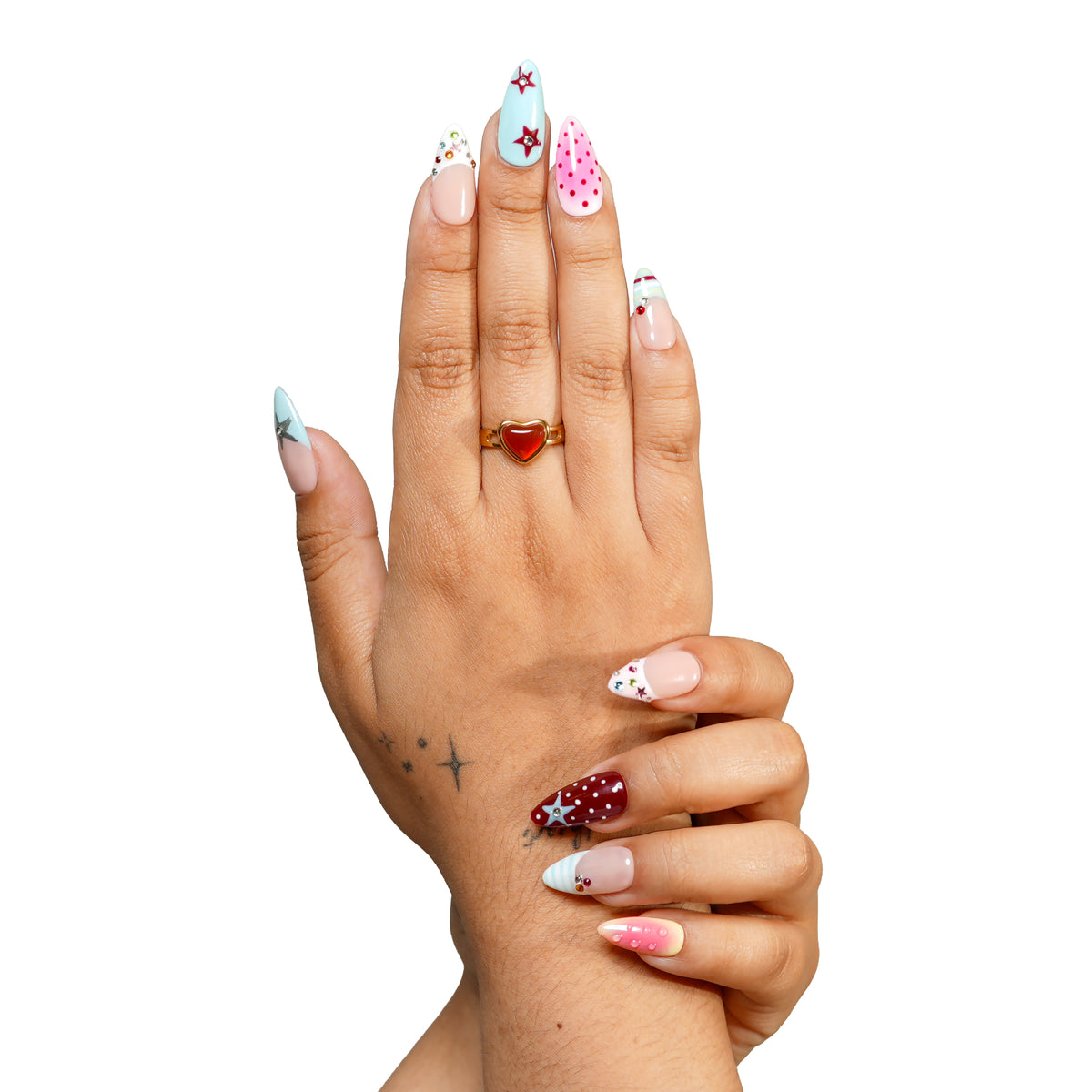 LA medium almond press-on nails by 3H Nails, featuring pastel blue, pink, burgundy, and nude designs with stars, polka dots, rhinestones, and ombre accents, shown on hands.