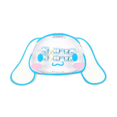A clear plastic tooth case shaped like Sanrio Cinnamonroll character, outlined in light blue, pink cheeks, and a small blue mustache. Inside the clear top section are several small tooth-shaped items arranged in rows.