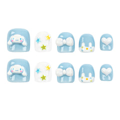 Ten square press-on nails arranged in two rows of five on a plain white background. The set includes light blue and white nails with cute cartoon bunny and bow designs, plus small star and heart details.