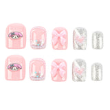 A set of 10 press-on nails arranged in two rows of five on a plain white background. The set features a mix of pastel pink and glittery silver designs, including solid pink, pink bows, pink My Melody cartoon character prints, and pink heart patterns with silver glitter.