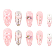 A set of 10 pink press-on nails arranged in two rows of five on a plain white background. The designs include glossy pink nails with bows, glittery pink nails with hearts, a pink-and-white cartoon character (My Melody) nail, silver rhinestone accents, and a white nail with a pink heart.