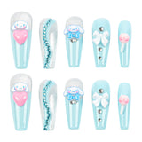 Ten decorative false nails arranged in two rows on a white background. The nails feature a light blue and white striped base with various embellishments including a Cinnamoroll cartoon character, a pink heart, rhinestones, a white bow, and a pink lollipop design.