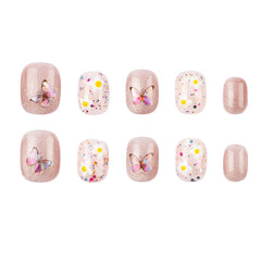 Ten press-on nails arranged in two rows on a plain white background. The set includes glittery nude-pink nails, clear white nails with multicolor confetti, and white nails with yellow dots and butterfly designs.