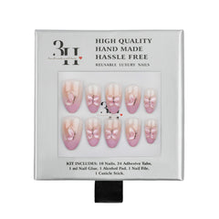 A 10-piece press-on nail kit in its original packaging, featuring pale pink and nude nails with delicate butterfly designs. The packaging is white with black text and a clear window displaying the nails.