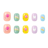 Ten pastel-colored nail wraps arranged in two rows of five on a plain white background. Each wrap features a different simple graphic: pink suns, rainbows, hearts, and stars in soft peach, mint green, yellow, lavender, and light blue.