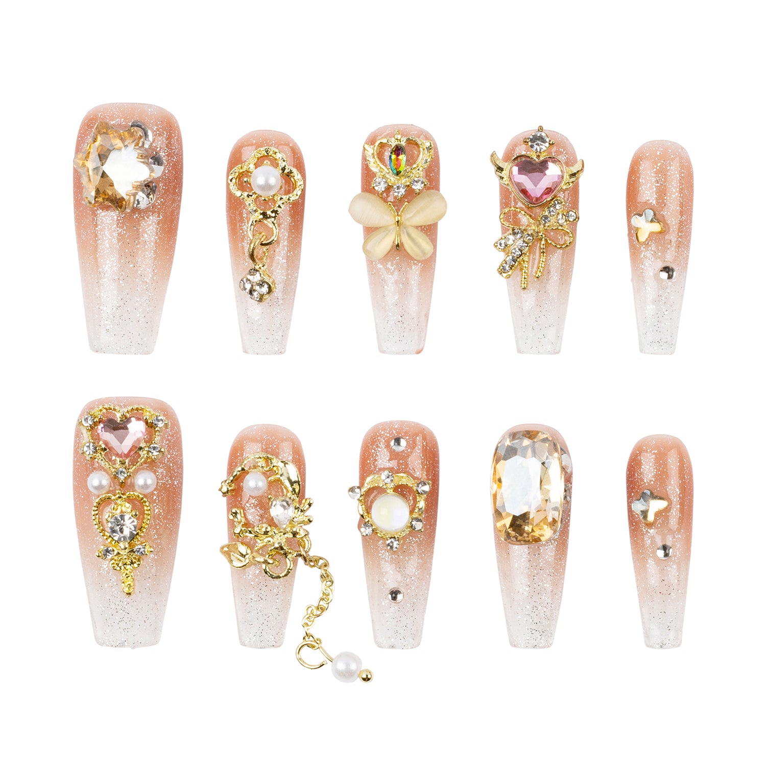 Ten coffin-shaped false nails with a pink-to-clear gradient, glitter finish, and various gold and pink rhinestone embellishments, arranged in two rows on a white background.