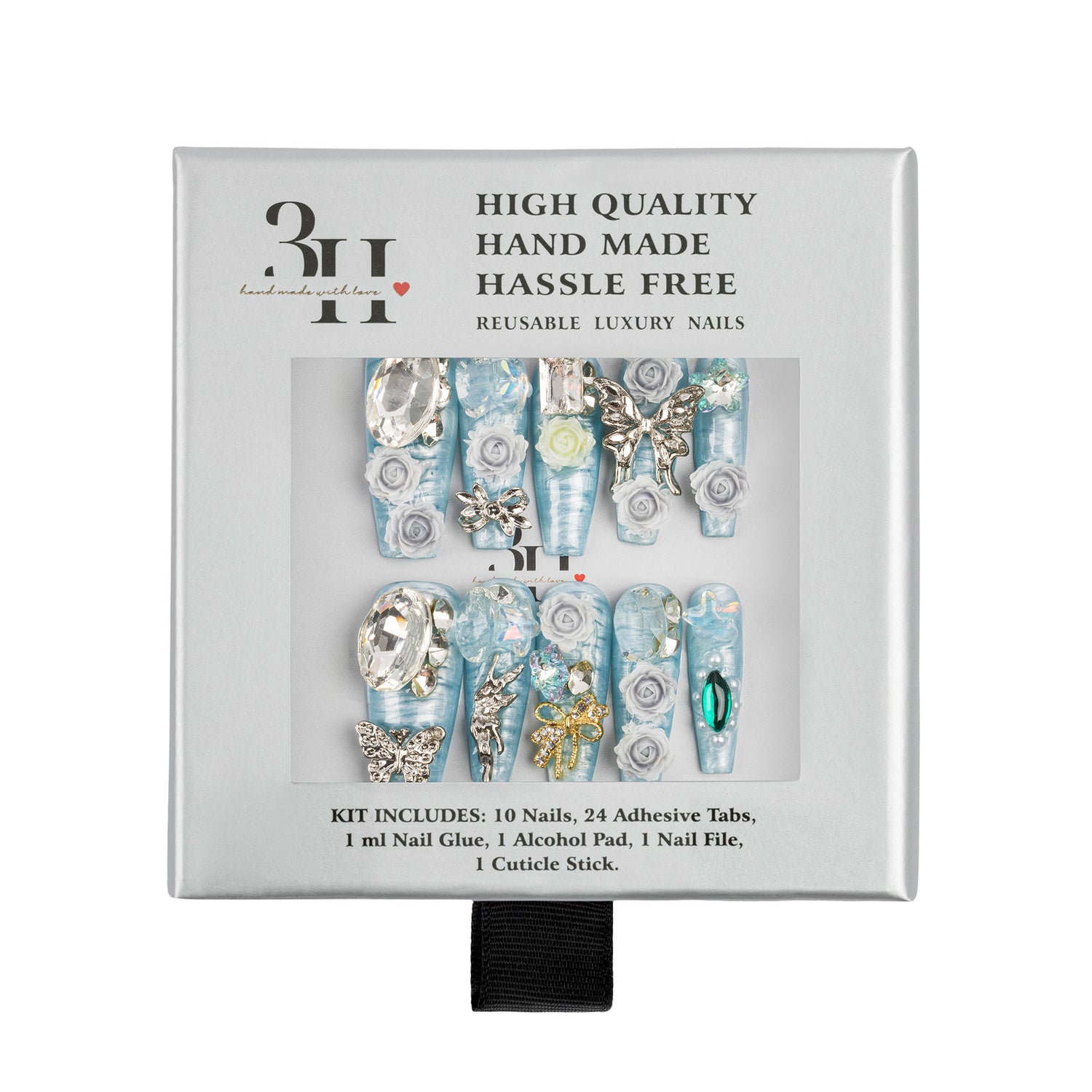 A boxed set of reusable luxury press-on nails. The white square package shows a clear window with ten long light blue and silver decorative nails, plus text reading 'HIGH QUALITY HAND MADE HASSLE FREE' and 'REUSABLE LUXURY NAILS.