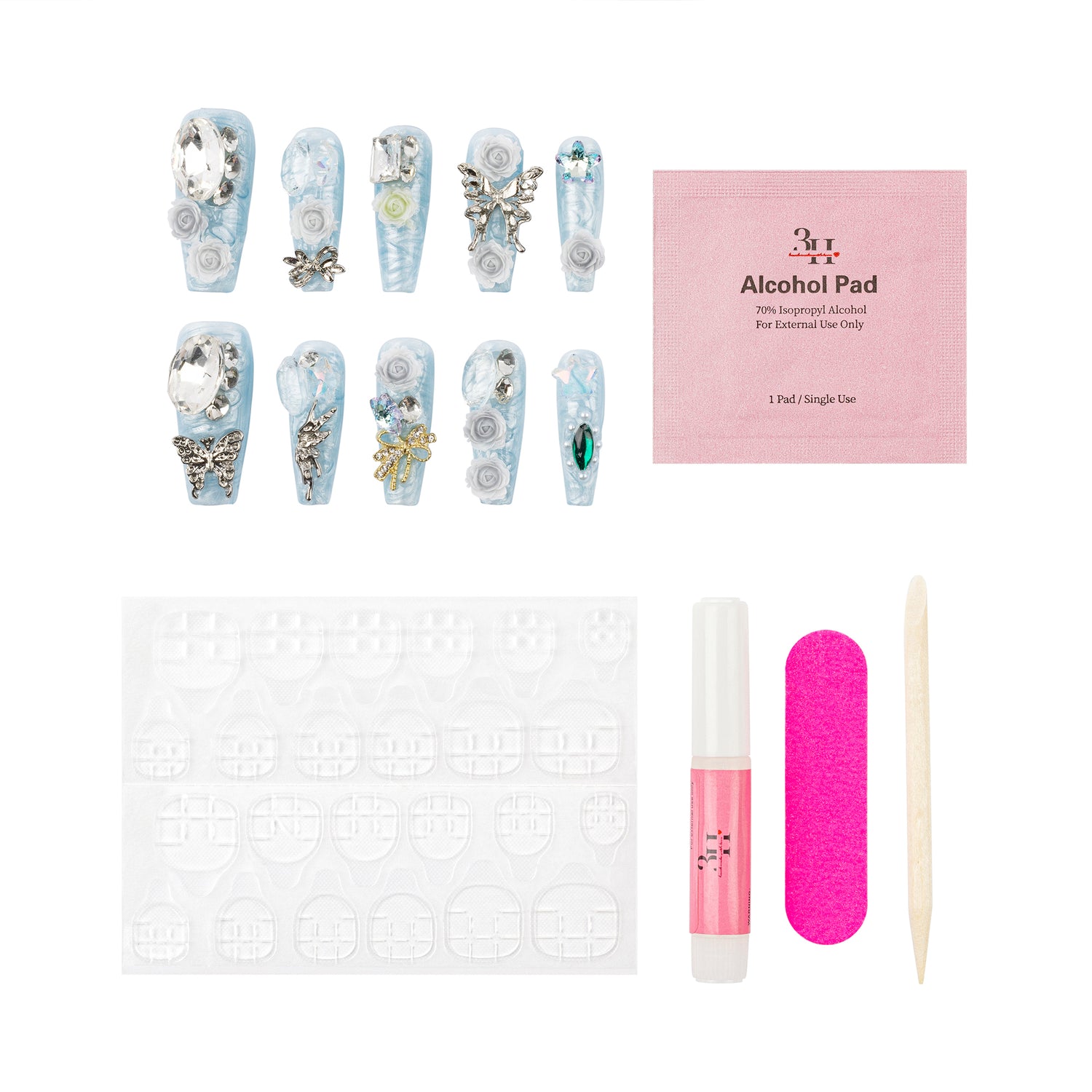 A nail art kit laid out on a white background, including decorated false nails, a pink packet labeled '365 ART Alcohol Pad', a white nail stamping plate, a bright pink nail file, a small pink bottle, and a wooden stick.