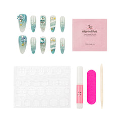 Nail art kit with six decorated false nails, a pink alcohol pad, a white stamping plate, a pink nail file, a pink nail polish bottle, and a wooden cuticle stick on a white background.
