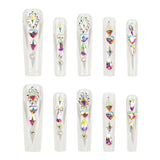 Ten clear press-on nails arranged in two rows of five, each decorated with multiple iridescent rhinestones and crystals in heart, oval, and triangle shapes on a plain white background.