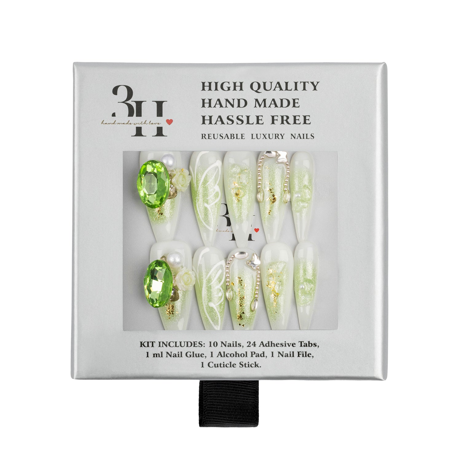 A boxed set of reusable press-on nails in a white package with a clear window showing the nails. The nails are mostly pale green and white with some gold glitter and one bright green gem accent.