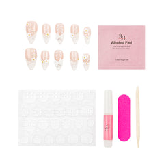 Nail art kit with decorative false nails, a pink packet of alcohol pads, adhesive tabs, a pink nail file, a pink nail polish tube, and a wooden cuticle stick on a white background.