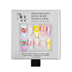A 10-piece press-on nail kit in its original packaging, featuring pastel-colored nails with various heart and bow designs.