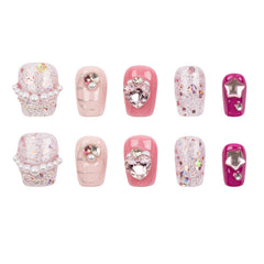 A set of ten artificial press-on nails arranged in two rows of five on a plain white background. The nails feature various pink and white glitter designs, pearl accents, rhinestones, and metallic star details.