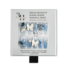 A 3H brand reusable press-on nail kit in its original white cardboard packaging, featuring light blue and white butterfly-themed nails with rhinestone and bead embellishments.