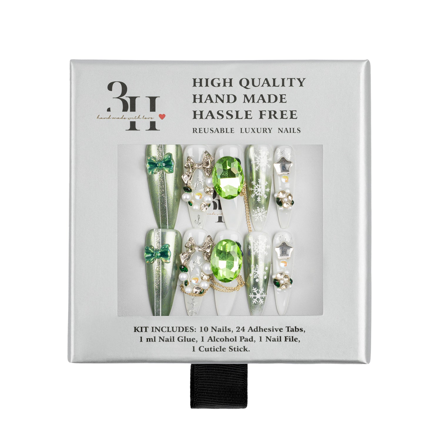 A boxed set of decorative press-on nails in a white retail package. The nails are long and embellished with green gem-like accents, silver rhinestones, bows, and metallic details.