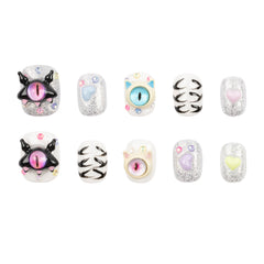 Ten decorative nail charms or bead-like accessories arranged in two rows on a plain white background. The set includes glittery silver pieces with pastel hearts and eyes, black-and-white cat-face designs, and pastel pink, blue, yellow, and lavender eye motifs.