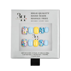 A 3H brand reusable press-on nail kit in its original silver packaging, featuring a set of ten nails with pastel blue, yellow, and multicolor glitter designs.