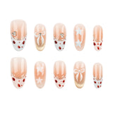 Ten-piece set of press-on nails with a holiday theme, featuring peach and white vertical stripes, red polka dots, white bows, white stars, and gold glitter accents on a white background.