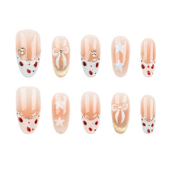 Ten-piece set of press-on nails with a holiday theme, featuring peach and white vertical stripes, red polka dots, white bows, white stars, and gold glitter accents on a white background.