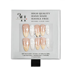 A 3H brand press-on nail kit in its original packaging, featuring 10 nude-beige and 10 white wing-patterned reusable luxury nails.