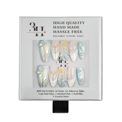 A 3H brand reusable press-on nail kit in its original packaging, featuring 10 long almond-shaped nails with white, gold, and blue designs, along with 24 adhesive tabs.