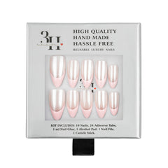 A 10-piece reusable press-on nail kit in its original packaging. The nails have a glossy pale pink base with a pearlescent white top layer, giving them a soft champagne finish.