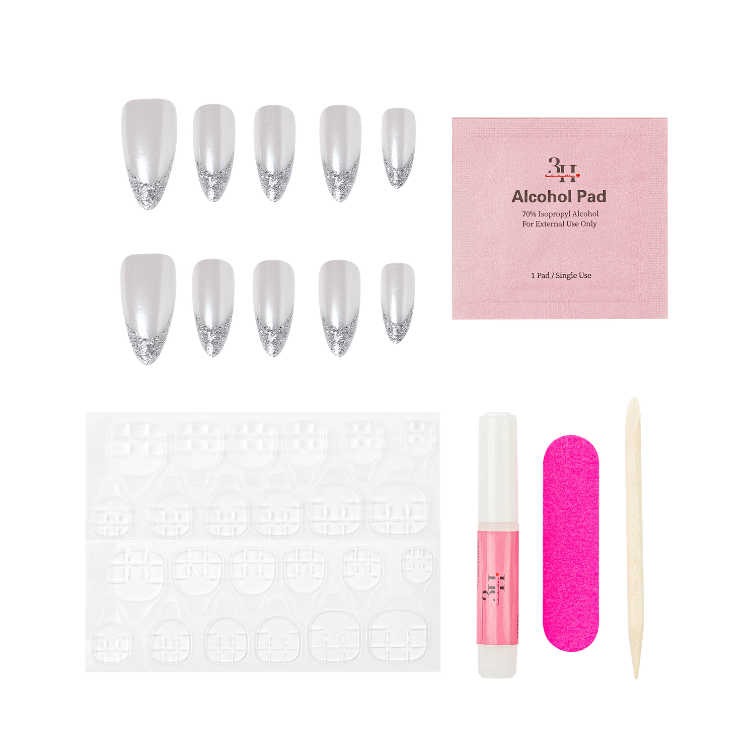 Nail art kit with silver glitter false nails, a pink alcohol pad, a white nail file, a pink nail glue tube, a wooden cuticle stick, and clear adhesive tabs on a white background.