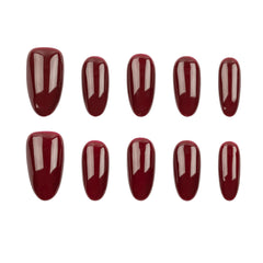 Ten glossy dark red press-on nails arranged in two rows on a plain white background.