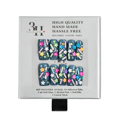 A boxed set of decorative press-on nails on a white background. The package text reads 'HIGH QUALITY HAND MADE HASSLE FREE' and 'REUSABLE LUXURY NAILS.