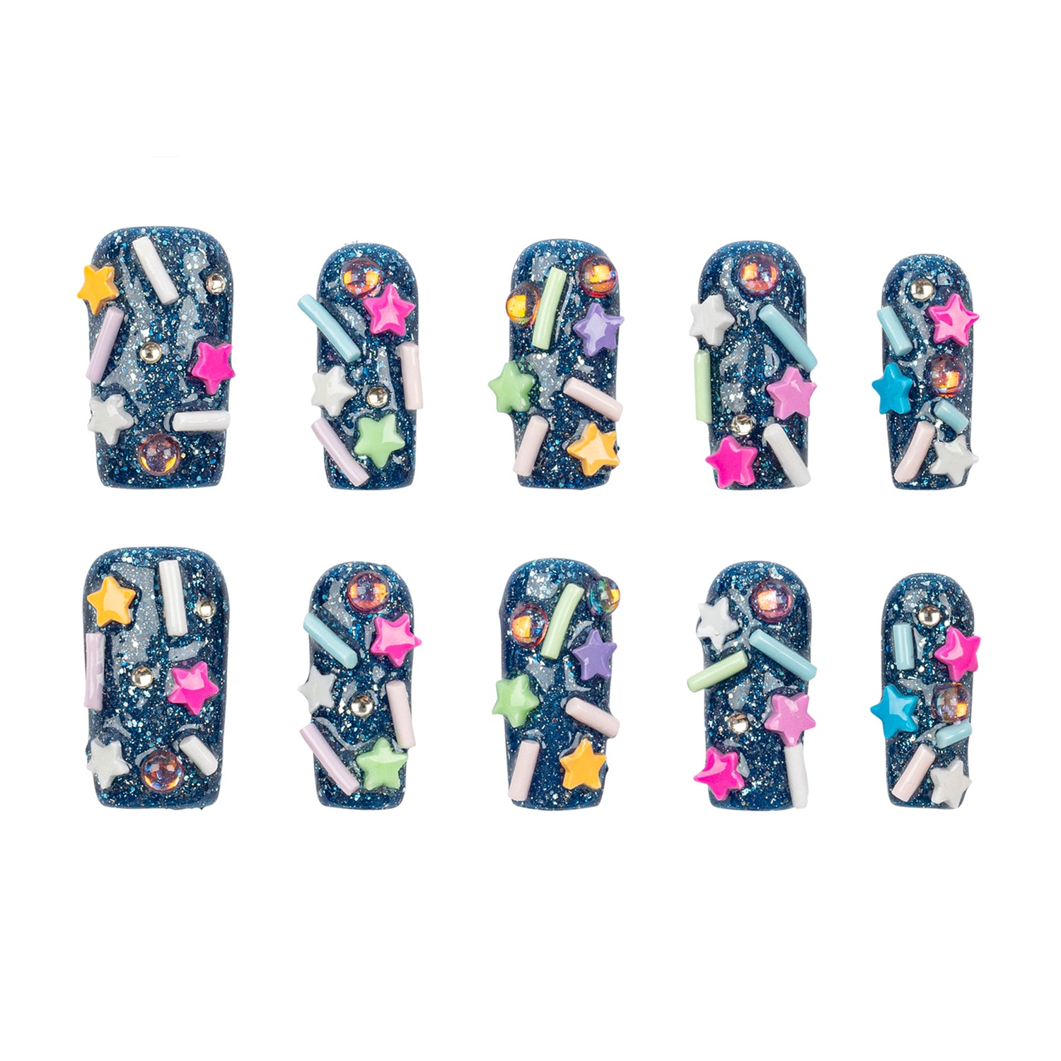 Ten false nail tips decorated with a dark blue glitter base and colorful star, sprinkle, and rhinestone embellishments, arranged in two rows on a white background.