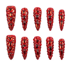 Ten red stiletto-shaped nail art stickers with intricate 3D crystal and bead designs, arranged in two rows of five on a plain white background.