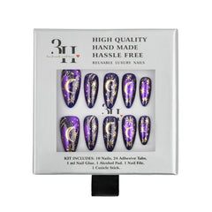 A 10-piece set of reusable press-on nails in a silver retail box. The nails are deep purple with metallic gold celestial designs of crescent moons and stars.