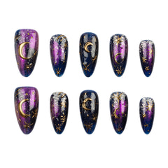 Ten almond-shaped press-on nails arranged in two rows of five on a plain white background. The nails feature a cosmic design with a purple-to-blue gradient, glitter, and gold celestial motifs including crescent moons and stars.