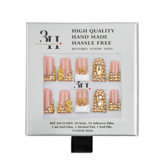 A 3H brand press-on nail kit in its original white cardboard packaging, featuring 10 pink and white decorative nails with gold glitter and bead designs.