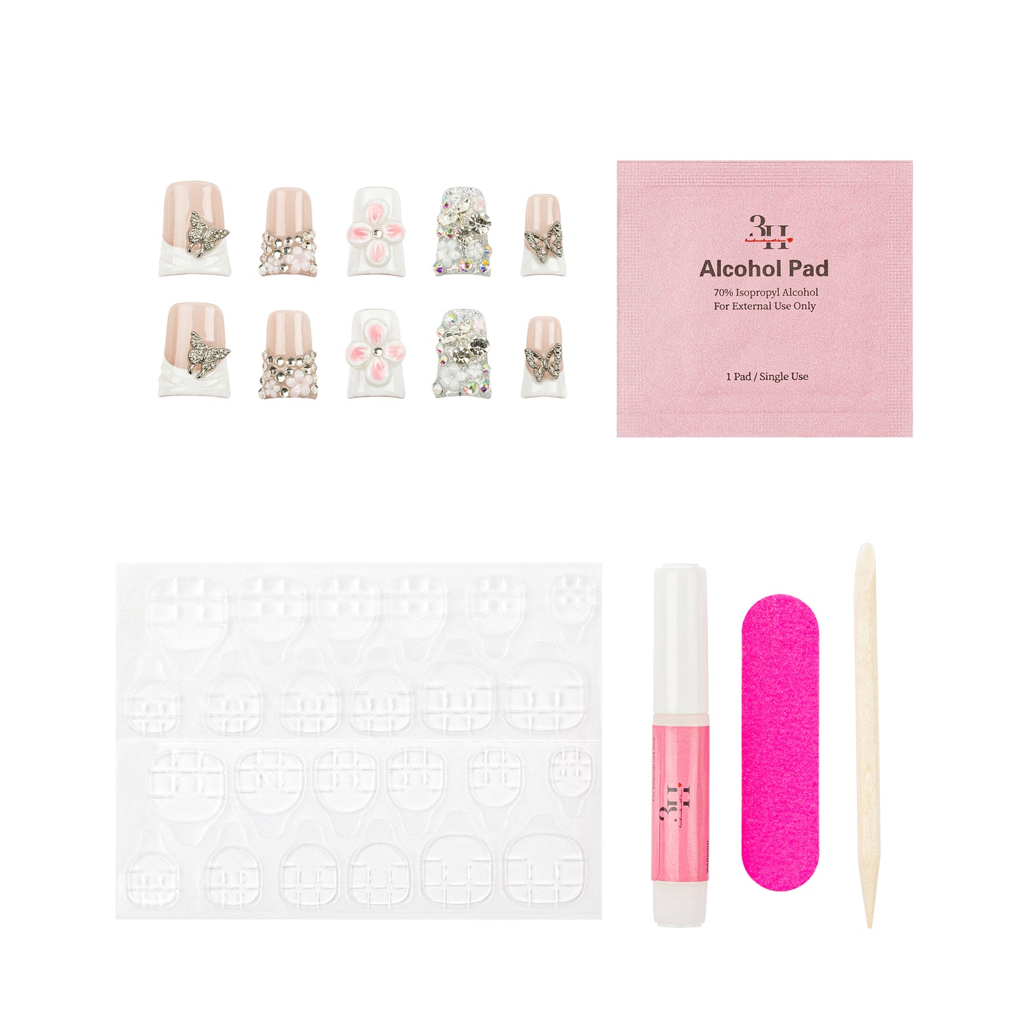 Nail art kit with false nails, a pink packet of alcohol pads, adhesive tabs, a pink nail file, a pink nail polish tube, and a wooden cuticle stick on a white background.