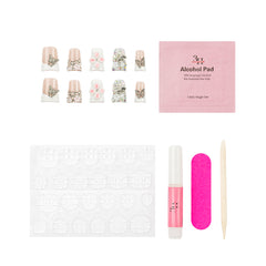 Nail art kit with false nails, a pink packet of alcohol pads, adhesive tabs, a pink nail file, a pink nail polish tube, and a wooden cuticle stick on a white background.