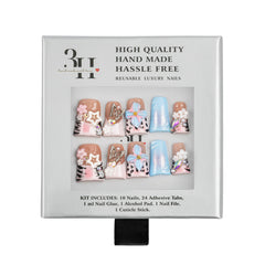 A 3H brand press-on nail kit in its original packaging, featuring 10 reusable luxury nail tips with various designs including leopard print, pink floral patterns, and iridescent blue glitter, along with adhesive tabs, nail glue, an alcohol pad, and a cuticle stick.