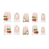 Ten false press-on nails arranged in two rows of five on a plain white background. The nails have a pale pink and white French tip design with some featuring red cherry embellishments with green leaves and gold decorative accents.