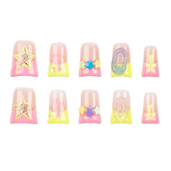 Ten false press-on nails arranged in two rows of five on a plain white background. The nails have a glossy pink base with pastel yellow, purple, and blue gradient accents, plus decorative star and swirl embellishments.