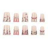 Ten false press-on nails arranged in two rows of five on a plain white background. The nails feature a glossy nude-pink base with glittery pink sections, leopard print spots, zebra stripes, and small pearl-like bead accents.
