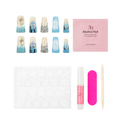 Nail art kit with decorative false nails, a pink packet of alcohol pads, adhesive tabs, a pink nail file, a pink nail glue tube, and a wooden tool on a white background.