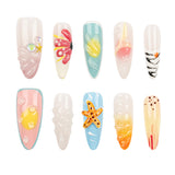 Ten false press-on nails arranged in two rows on a plain white background. The nails feature various pastel and bright beach-themed designs including seashells, starfish, bubbles, and abstract patterns in pink, blue, yellow, orange, and white.
