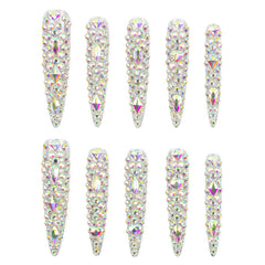 Ten long stiletto-shaped nail tips decorated with dense iridescent rhinestones, arranged in two rows of five on a plain white background.