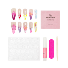Nail art kit with decorative false nails, a pink alcohol pad packet, adhesive tabs, a pink nail file, a pink nail glue tube, and a wooden tool on a white background.