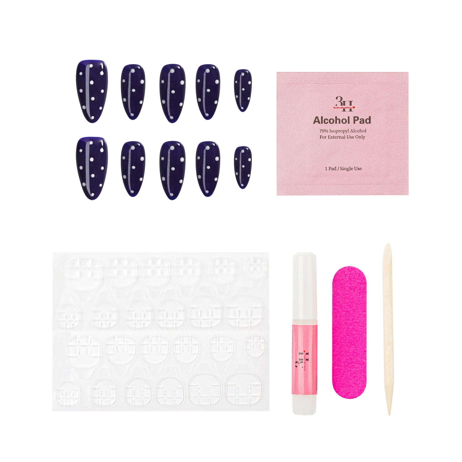 Set of polka dot nail press-ons, alcohol pad, adhesive tabs, pink nail file, and wooden stick on a white background.